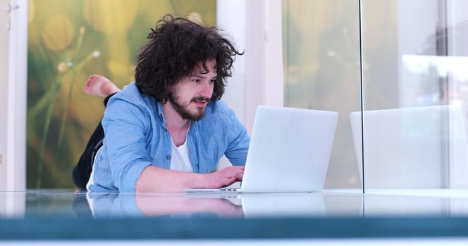 Real man Using laptop on the floor At Home  Enjoying Relaxing