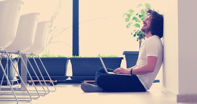 Real man Using laptop on the floor At Home  Enjoying Relaxing