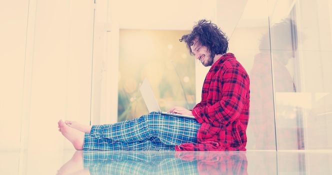 Real man Using laptop on the floor At Home  Enjoying Relaxing