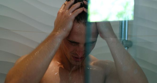 Young man taking a shower