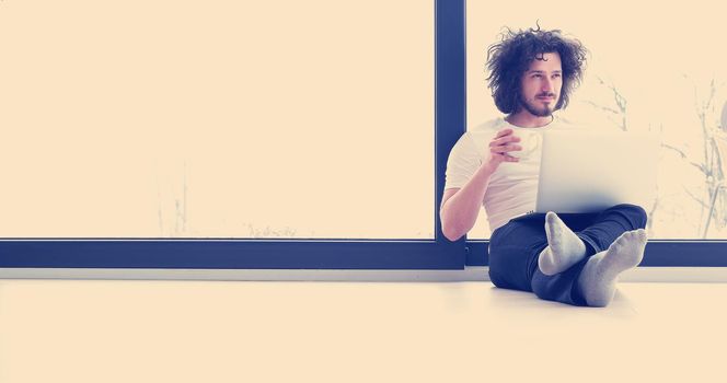 Real man Using laptop on the floor At Home  Enjoying Relaxing