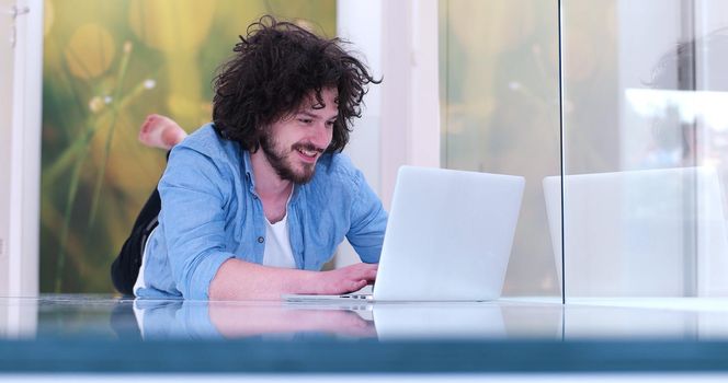 Real man Using laptop on the floor At Home  Enjoying Relaxing