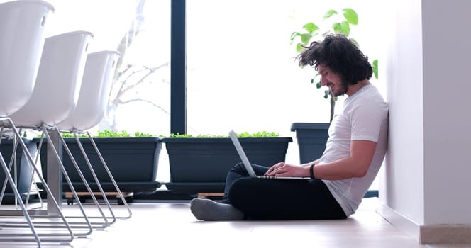 Real man Using laptop on the floor At Home  Enjoying Relaxing