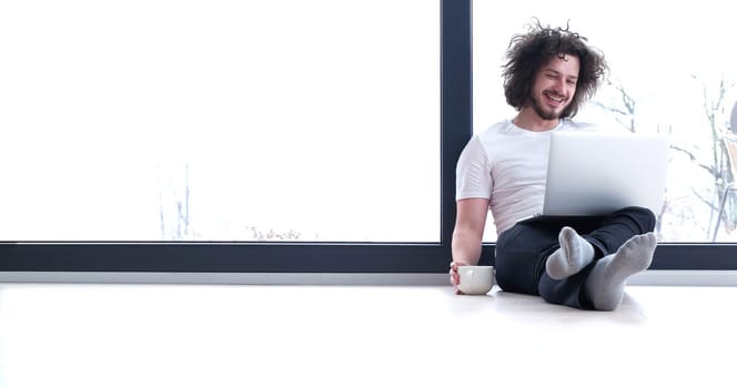 Real man Using laptop on the floor At Home  Enjoying Relaxing