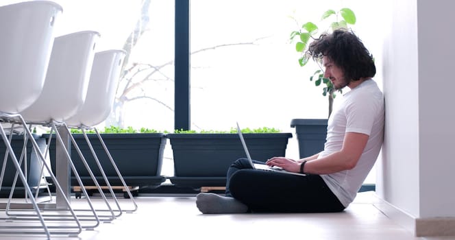 Real man Using laptop on the floor At Home  Enjoying Relaxing