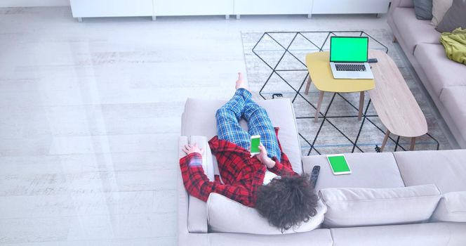 Young couple on the sofa watching television together in their luxury home