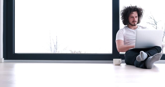 Real man Using laptop on the floor At Home  Enjoying Relaxing