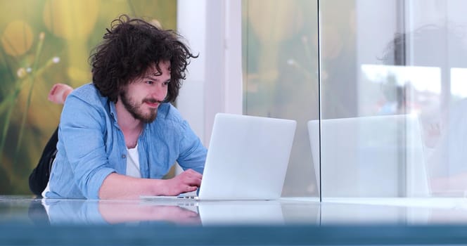 Real man Using laptop on the floor At Home  Enjoying Relaxing