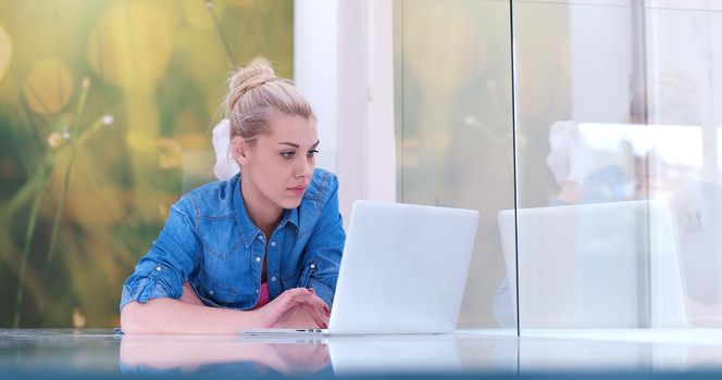 beautiful young women using laptop computer on the floor of her luxury home