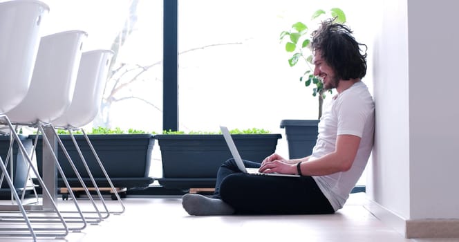 Real man Using laptop on the floor At Home  Enjoying Relaxing