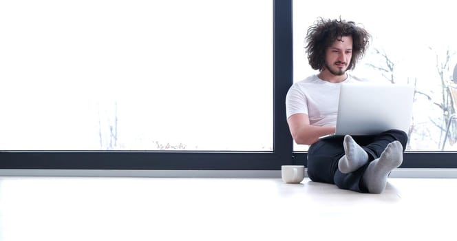 Real man Using laptop on the floor At Home  Enjoying Relaxing