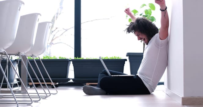 Real man Using laptop on the floor At Home  Enjoying Relaxing