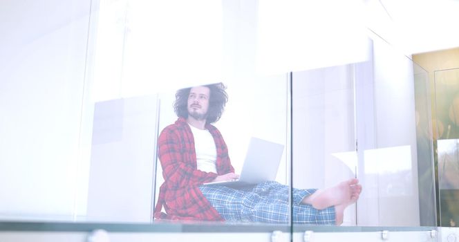 Real man Using laptop on the floor At Home  Enjoying Relaxing