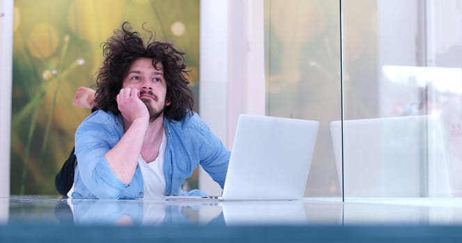 Real man Using laptop on the floor At Home  Enjoying Relaxing