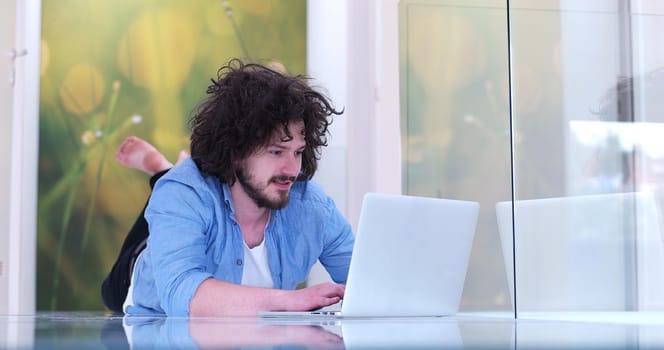 Real man Using laptop on the floor At Home  Enjoying Relaxing