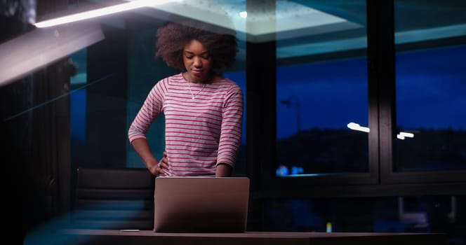 Young african american female Entrepreneur Freelancer Working Using A Laptop In night Coworking space