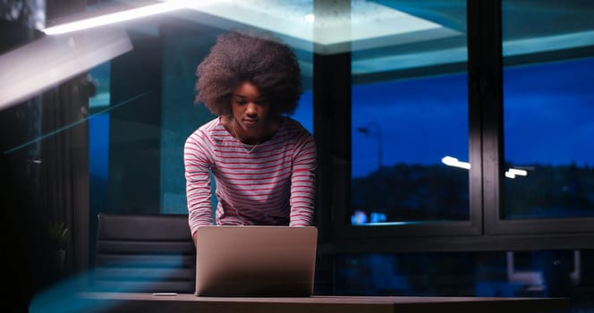 Young african american female Entrepreneur Freelancer Working Using A Laptop In night Coworking space