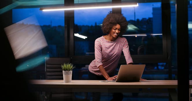 Young african american female Entrepreneur Freelancer Working Using A Laptop In night Coworking space