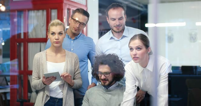 Group of a young business people discussing business plan at modern startup office building