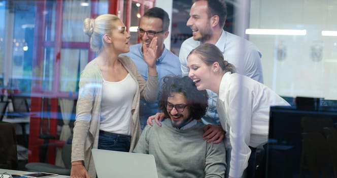 Group of a young business people discussing business plan at modern startup office building