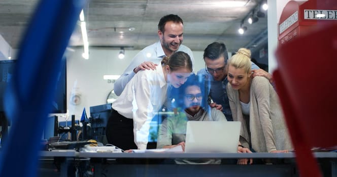 Group of a young business people discussing business plan at modern startup office building