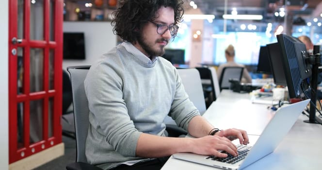 Young Entrepreneur Freelancer Working Using A Laptop In Coworking space