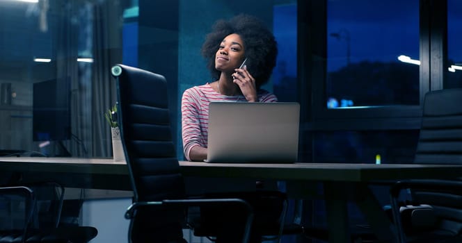 Young african american female Entrepreneur Freelancer Working Using A Laptop In night Coworking space