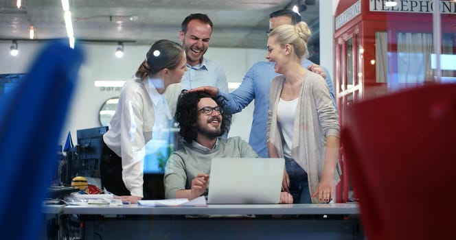 Group of a young business people discussing business plan at modern startup office building