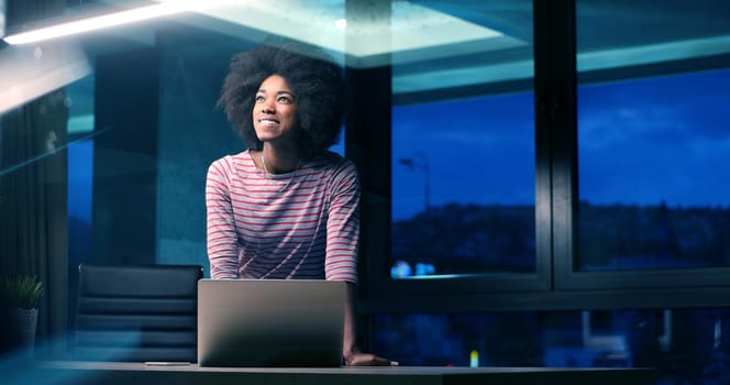 Young african american female Entrepreneur Freelancer Working Using A Laptop In night Coworking space