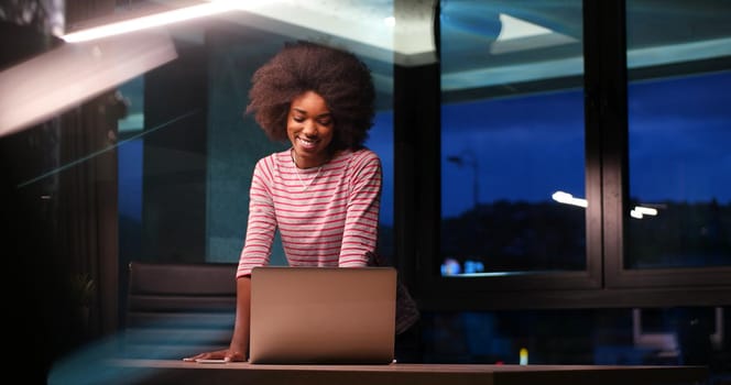 Young african american female Entrepreneur Freelancer Working Using A Laptop In night Coworking space