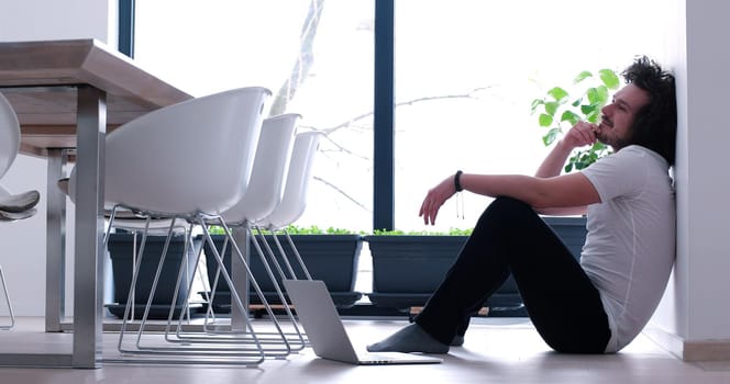 Real man Using laptop on the floor At Home  Enjoying Relaxing