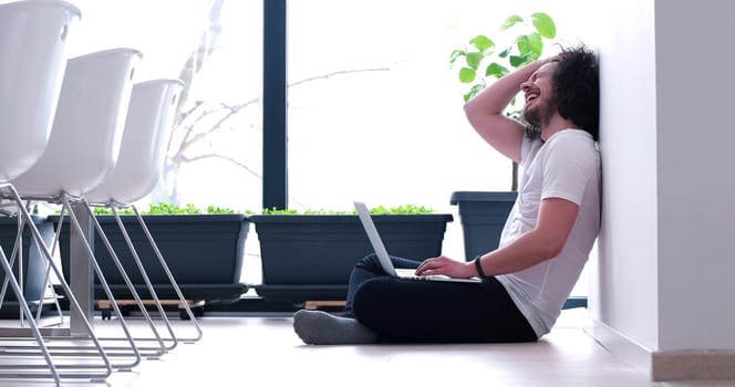 Real man Using laptop on the floor At Home  Enjoying Relaxing