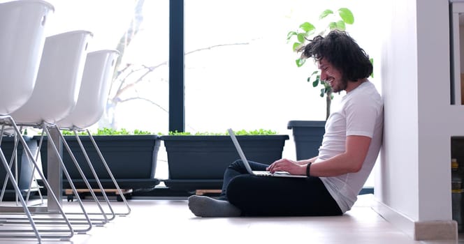 Real man Using laptop on the floor At Home  Enjoying Relaxing