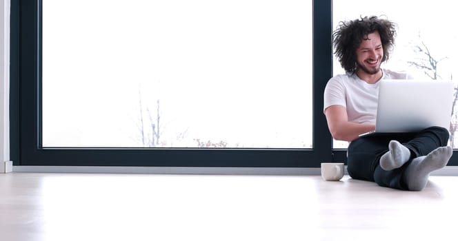 Real man Using laptop on the floor At Home  Enjoying Relaxing