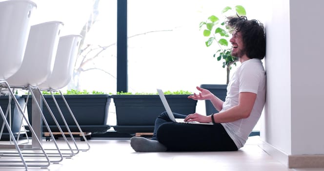 Real man Using laptop on the floor At Home  Enjoying Relaxing