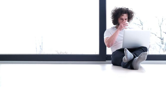 Real man Using laptop on the floor At Home  Enjoying Relaxing