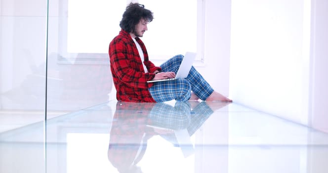 Real man Using laptop on the floor At Home  Enjoying Relaxing