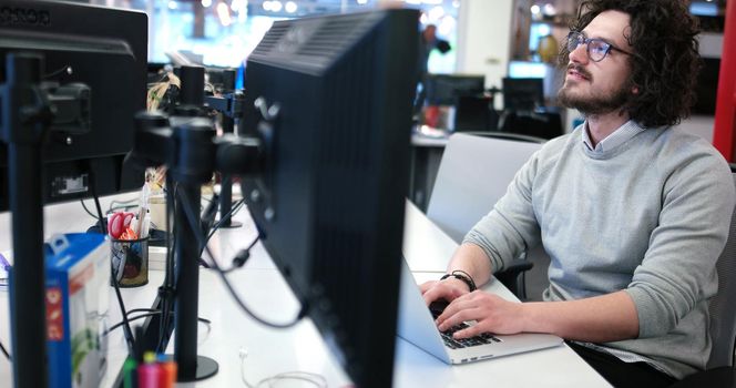 Young Entrepreneur Freelancer Working Using A Laptop In Coworking space