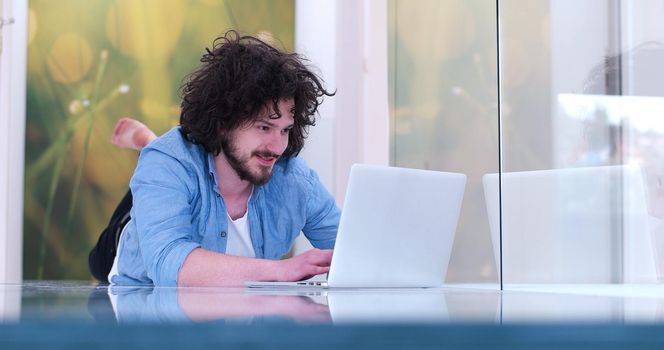 Real man Using laptop on the floor At Home  Enjoying Relaxing