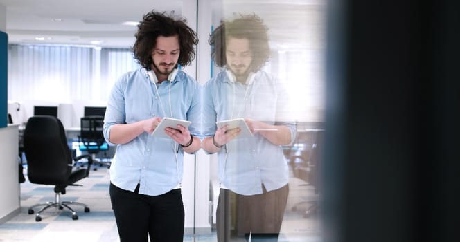 young casual businessman using tablet computer in startup office