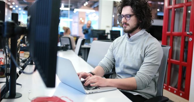 Young Entrepreneur Freelancer Working Using A Laptop In Coworking space