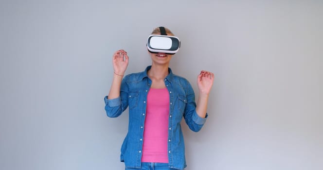 Happy girl getting experience using VR headset glasses of virtual reality, isolated on white background