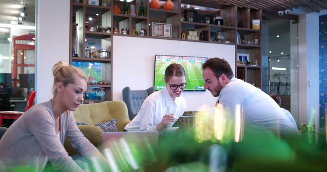 Group of a young business people discussing business plan at modern startup office building