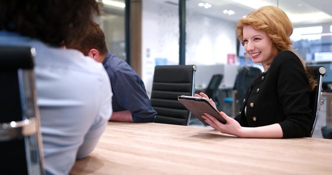 Group of a young business people discussing business plan at modern startup office building