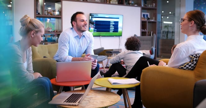 Group of a young business people discussing business plan at modern startup office building