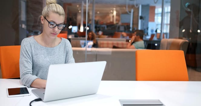 Young female Entrepreneur Freelancer Working Using A Laptop In Coworking space