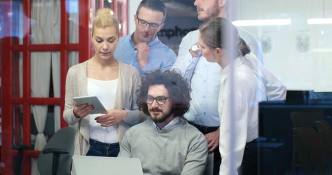 Group of a young business people discussing business plan at modern startup office building