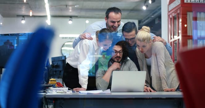 Group of a young business people discussing business plan at modern startup office building