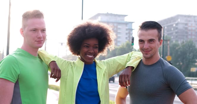 Portrait of multiethnic group of young people on the jogging beautiful summer morning as the sunrise over the city