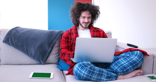 Real man Using laptop At Home Drinking Coffee Enjoying Relaxing